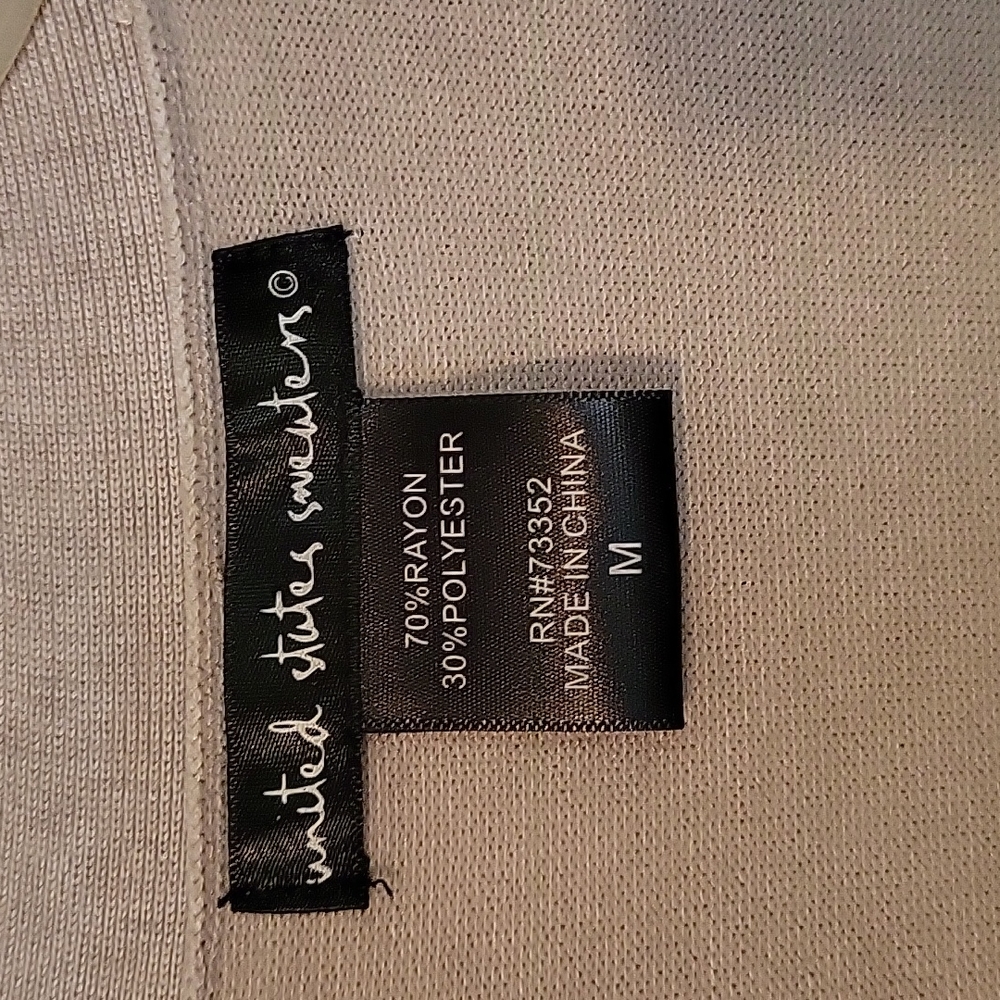 Very light in weight, medium size, tan sweater. Like new.